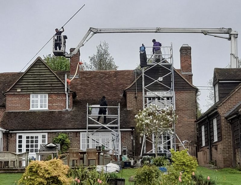 The Roof Moss Cleaners using cherry picker and scaffolding to clean roof safely and professionally in Charlbury, Oxfordshire